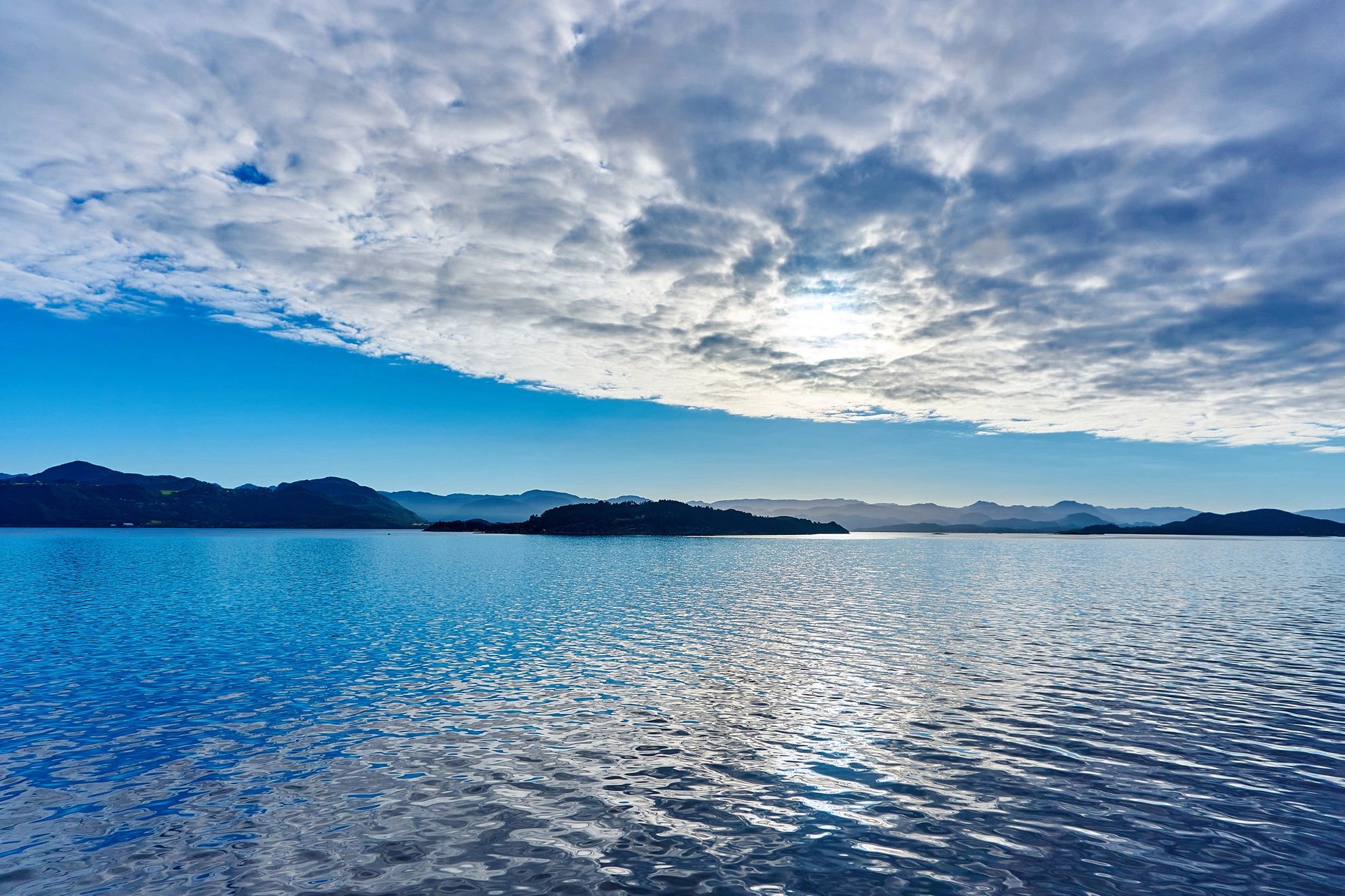 Serene seascape with calm blue water and mountainous coastline